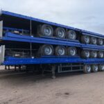 STACKS OF 5 USED FLATBED TRI-AXLE TRAILERS